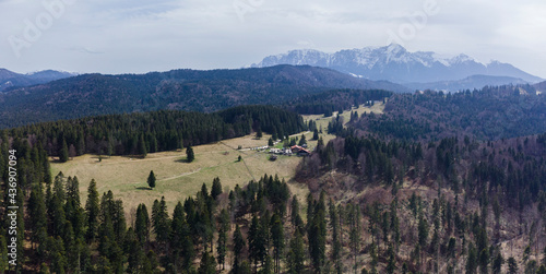Aerial view of Poiana Secuilor cabin with Bucegi mountains in the background.