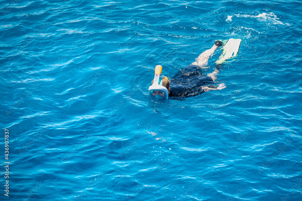 snorkeling concept. Woman exploring blue sea while snorkeling in summer day. snorkeling Swimming Summer Vacation Concept