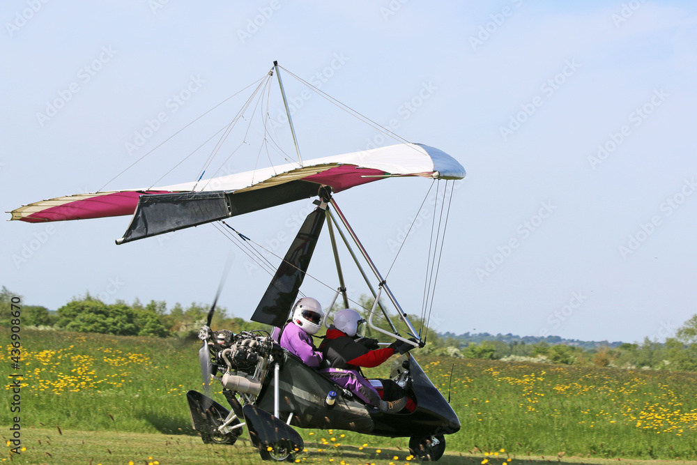 	
Ultralight airplane taxiing on a grass strip	