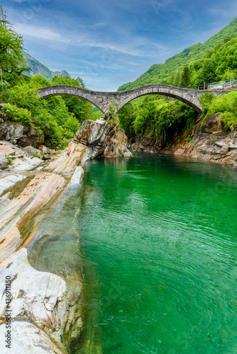View of Bridge Ponte dei Salti to Verzasca River at Lavertezzo - clear and turquoise water stream and rocks in Ticino - Valle Verzasca - Valley in Tessin - Travel destination in Switzerland photo