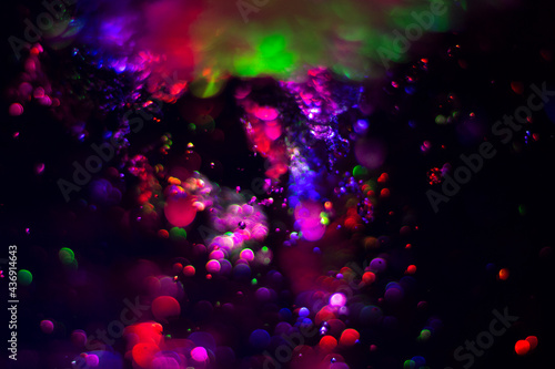 Colored water texture. Splashes of water lit in different colors.