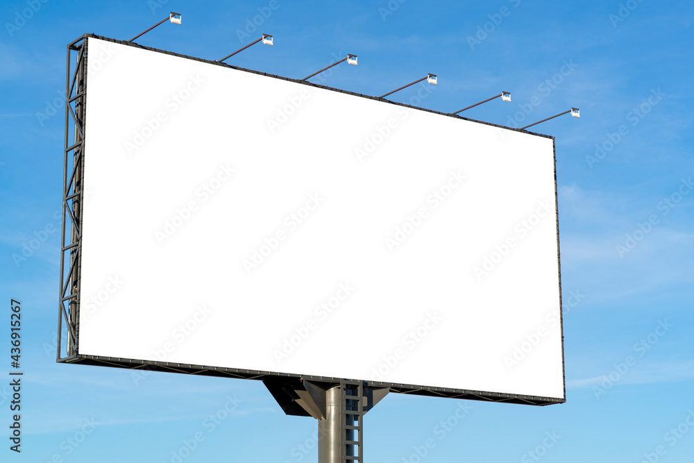 Blank horizontal billboard against blue sky background. White big board mock up for advertising, marketing, information Blank horizontal billboard against blue sky background. White big board mock up for advertising, marketing, information