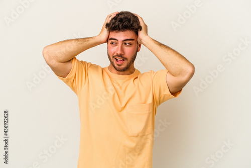 Young caucasian man isolated on white background screaming, very excited, passionate, satisfied with something.