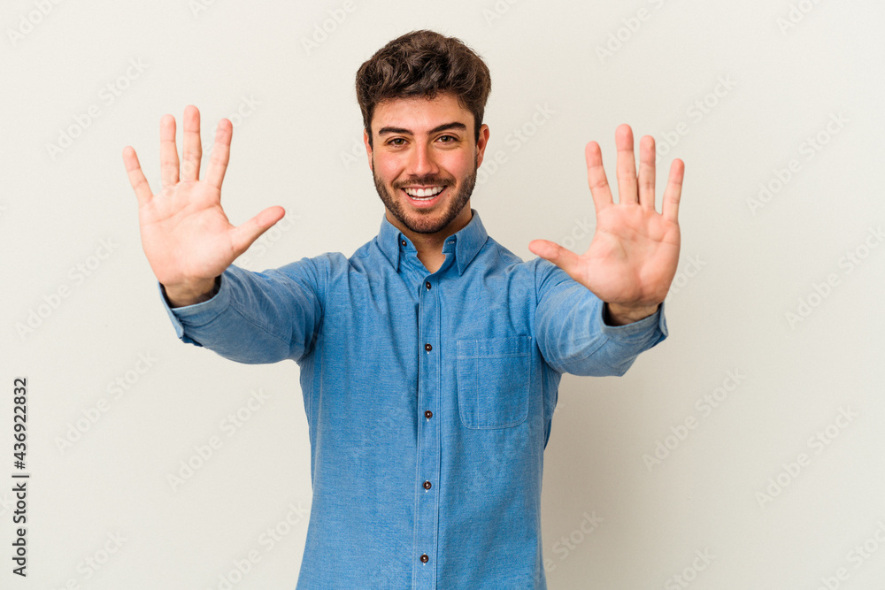 Young caucasian man isolated on white background showing number ten with hands. Young caucasian man isolated on white background showing number ten with hands.