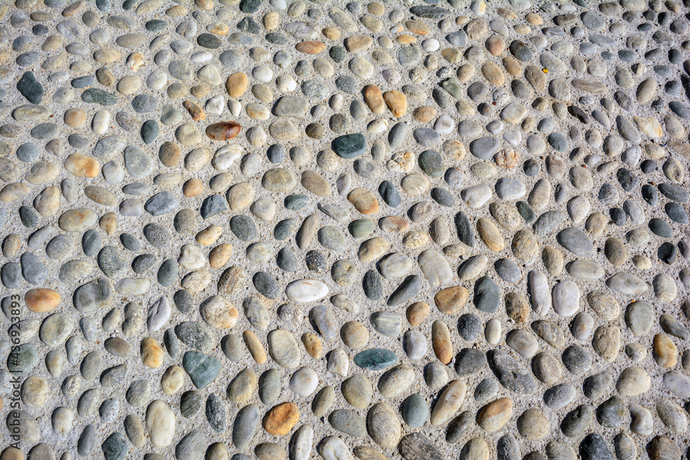 Round cobblestone (pebble) in concrete, street (road) pavement Round cobblestone (pebble) in concrete, street (road) pavement