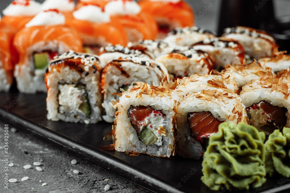 Sushi set with fresh ingredients on gray background. Sushi menu. Japanese food Sushi set with fresh ingredients on gray background. Sushi menu. Japanese food