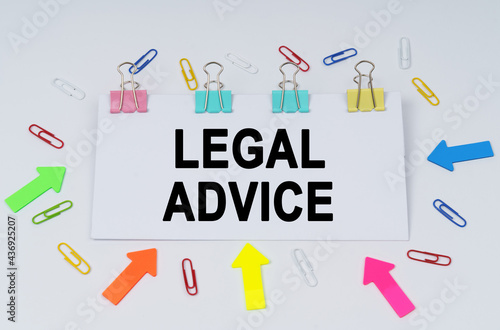 On the table there are paper clips and directional arrows, a sign that says - LEGAL ADVICE