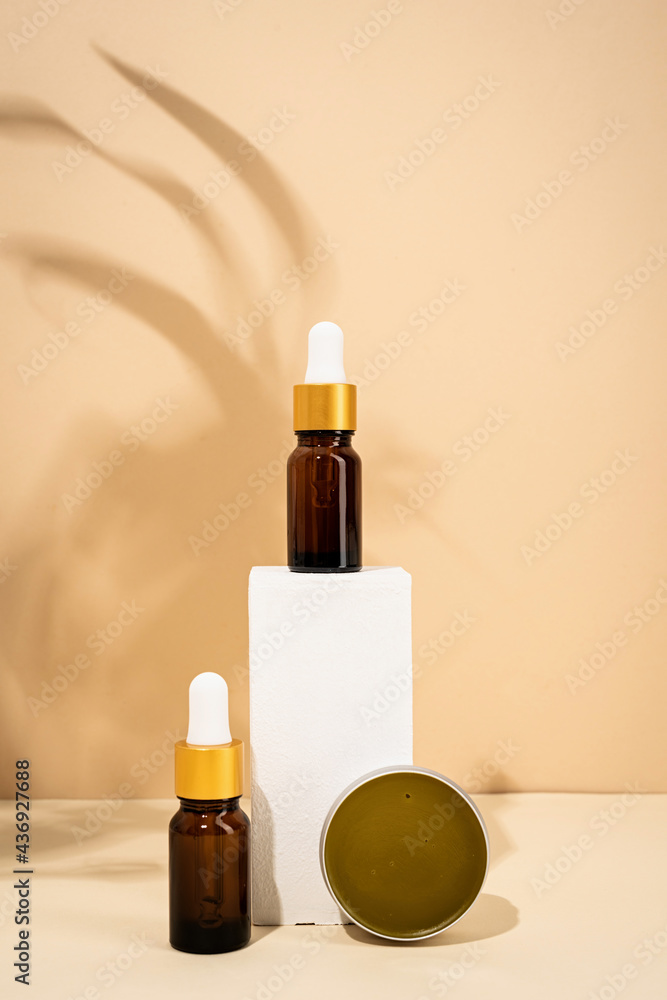 brown bottles mockup for natural skincare cosmetics, spa accessories on white podiums, cream background brown bottles mockup for natural skincare cosmetics, spa accessories on white podiums, cream background