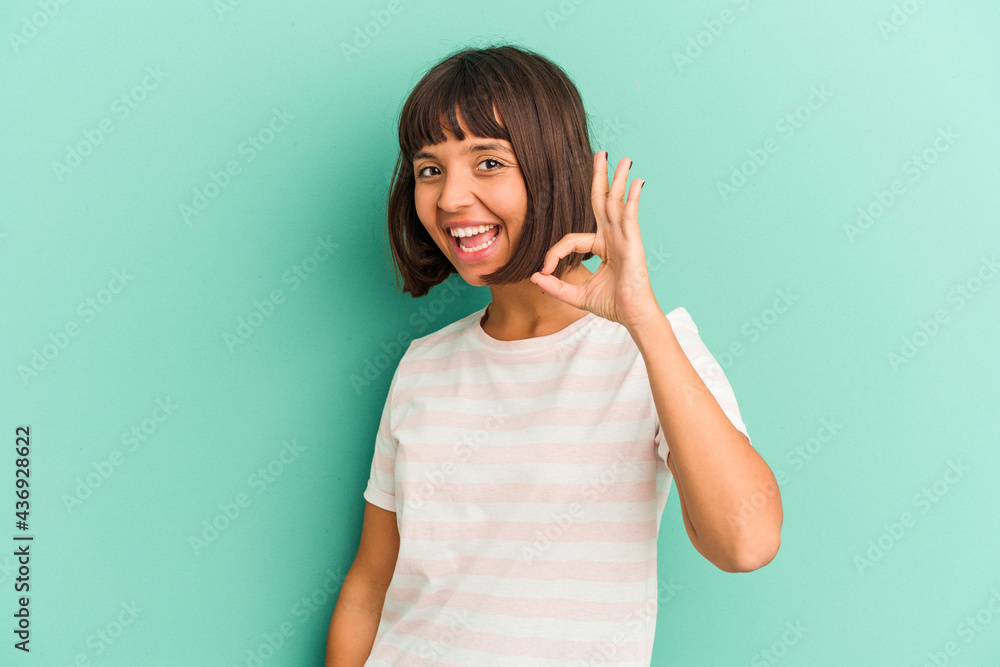 Young mixed race woman isolated on blue background yawning showing a tired gesture covering mouth with hand. Young mixed race woman isolated on blue background yawning showing a tired gesture covering mouth with hand.
