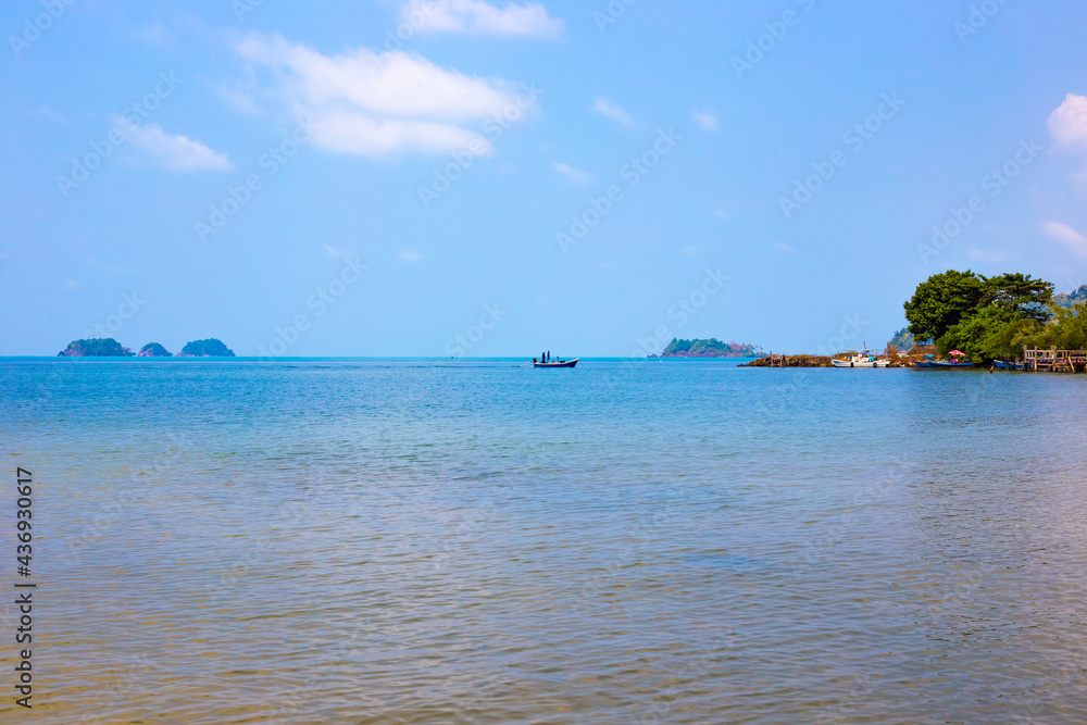 Seascape. A fisherman's boat is sailing on the sea in the background. Travel and tourism.