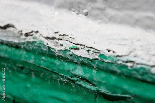 The junction of green and white paint close-up on the platband