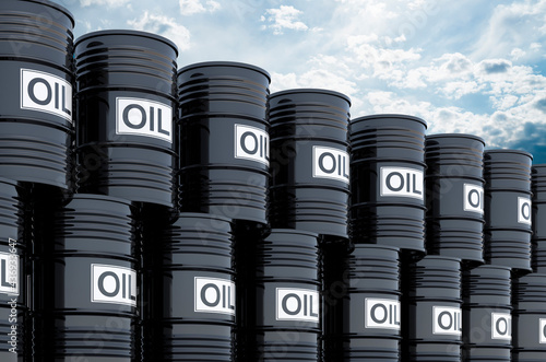 Stack of black oil barrels against blue sky, 3d rendering photo