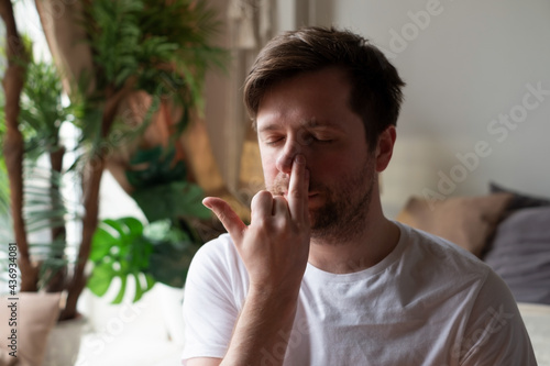 Obraz na plátně Caucasian mature man practicing yoga sitting, making Alternate Nostril Breathing