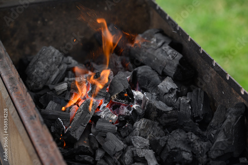 the process of lighting charcoal in the grill