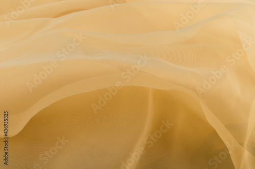 Yellow color tulle fabric texture  with beautiful closeup and elegance detail fabric background © Olga