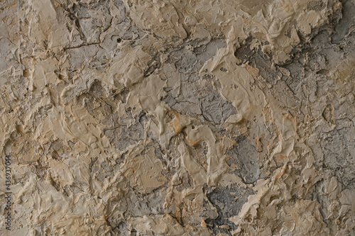 A concrete wall covered with beige paint