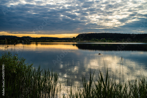 sunset at coast of the lake. Nature landscape.  reflection  blue sky and yellow sunlight. landscape during sunset.