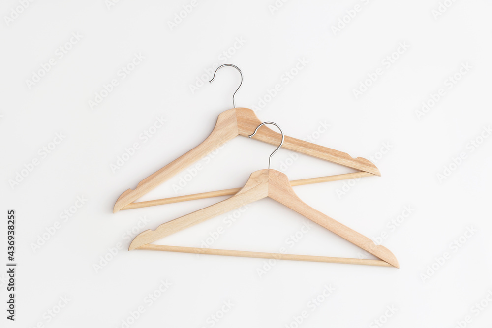 Wooden hangers on white background. Top view. Flat lay.Wooden hangers on white background. Top view. Flat lay. Wooden hangers on white background. Top view. Flat lay.Wooden hangers on white background. Top view. Flat lay.