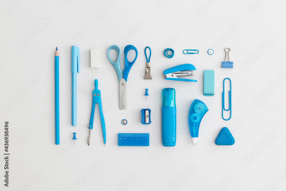 Blue school stationery on a grey background. Top view. Flat lay. Back to school concept.