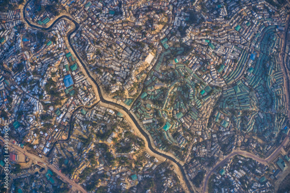 Aerial view of a huge refugee camp with makeshift houses near Myanmar border, Kutupalong Rohingya camp near Ukhia town, Bangladesh. Aerial view of a huge refugee camp with makeshift houses near Myanmar border, Kutupalong Rohingya camp near Ukhia town, Bangladesh.