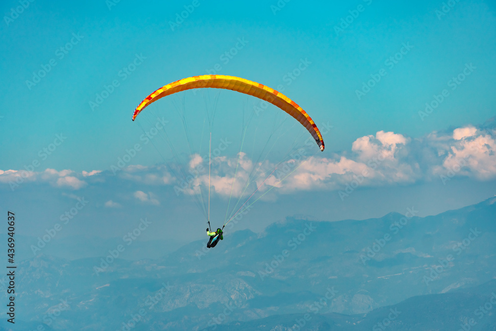 Paraglider sportsman fly over mountains Paraglider sportsman fly over mountains