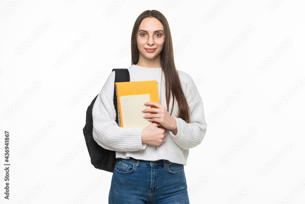 Young pretty student woman with backpack and exercise books. isolated on white background Young pretty student woman with backpack and exercise books. isolated on white background