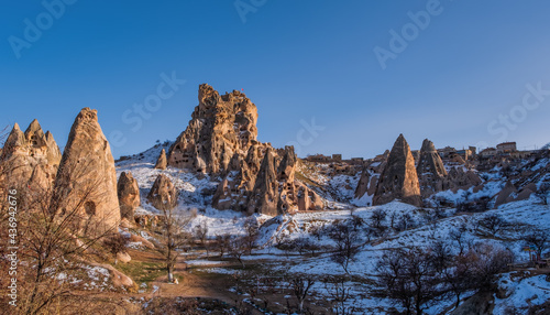 the Uchisar castle is a tall vulcanic rock outcrop riddled with tunnels and windows visible for miles around in Cappadocia, Turkey. February 2021