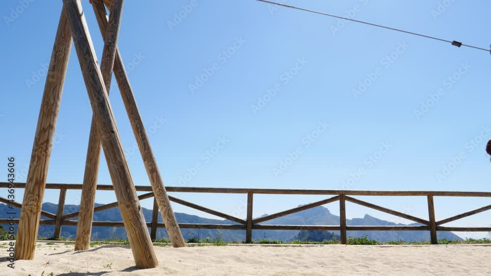 Adult freedom woman tourist having fun on zipline, descend on rope, cable aerial ropeslide. Mountains rest area place in Spain Alicante region. Costa Blanca holiday. Adult freedom woman tourist having fun on zipline, descend on rope, cable aerial ropeslide. Mountains rest area place in Spain Alicante region. Costa Blanca holiday.