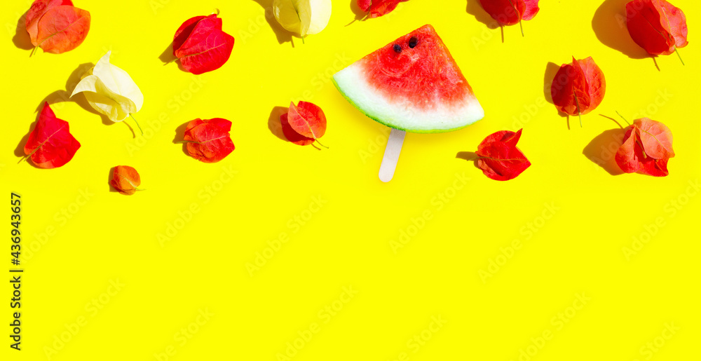 Watermelon slice popsicle with bougainvillea flowers on yellow background. Watermelon slice popsicle with bougainvillea flowers on yellow background.