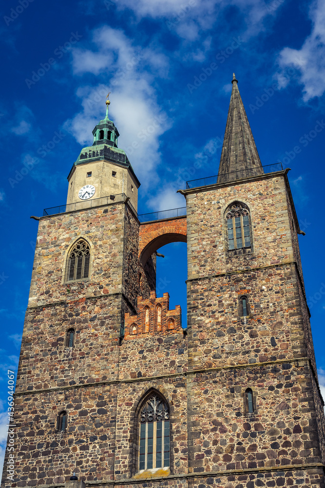 Fototapeta premium Two towers of the Church of St. Nicholas. Juterbog is a historic town in north-eastern Germany, in the district of Brandenburg.