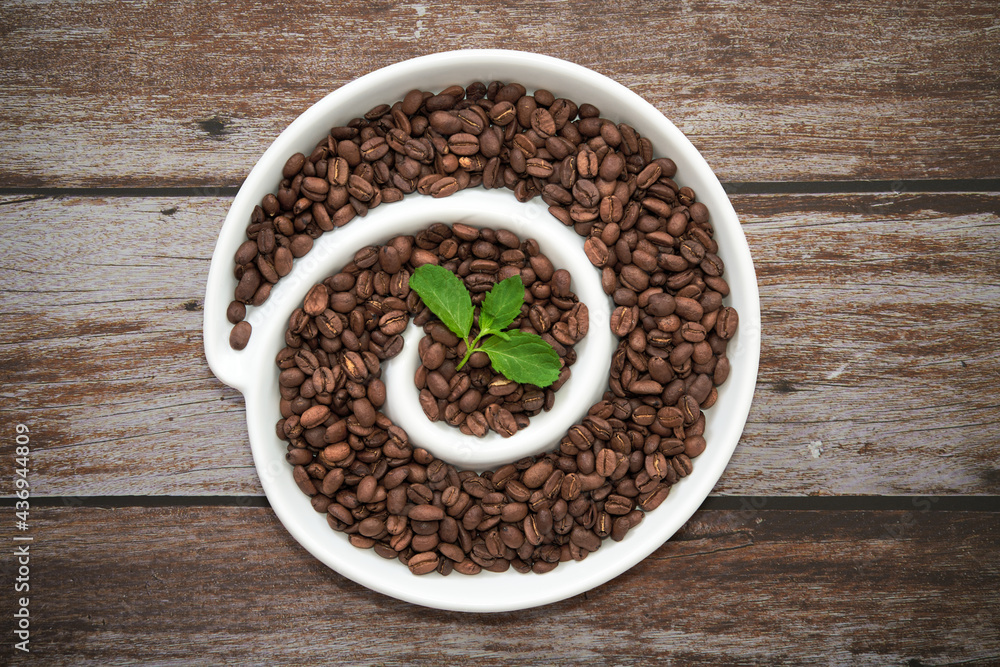 Top view on a spiral with espresso beans on a brown background. Top view on a spiral with espresso beans on a brown background.