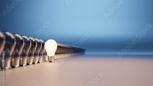 Lights bulbs in a row with one lit and with room for text photo