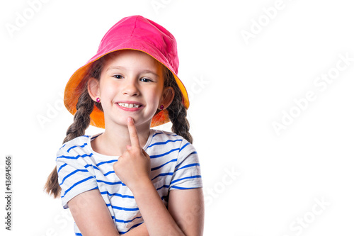 Cute european smiling little girl with pink hat and pigtails isolated on white background.