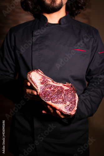 Chef holding a Rib Eye Steak USDA Prime Dry-aged