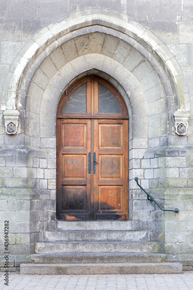 A gothic door with pointed arch on the gothic church of Saint Gery (Gaugericus) in Valenciennes.