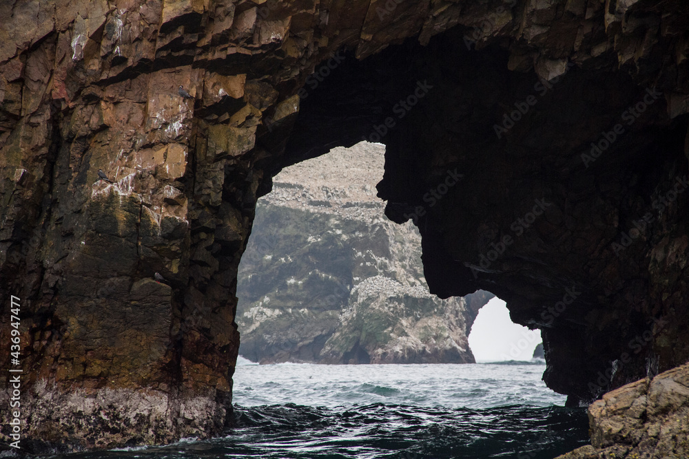 Rock cave on a shore with the shape of a face