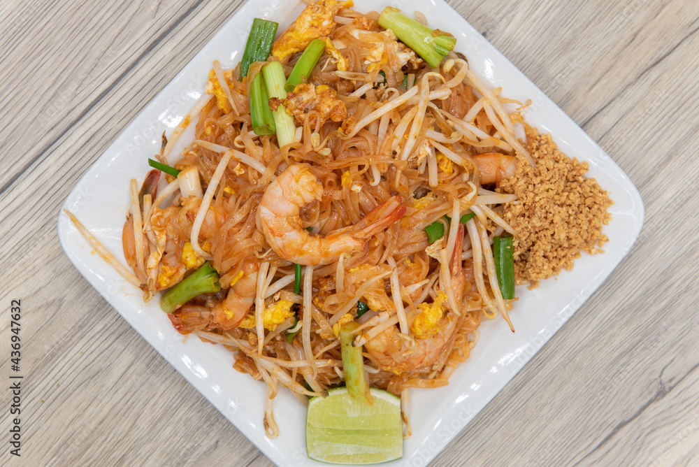 Overhead view of large pile of bean sprouts and stir fried vegetables topped with spicy thai shrimp for that delicious explosion of flavor