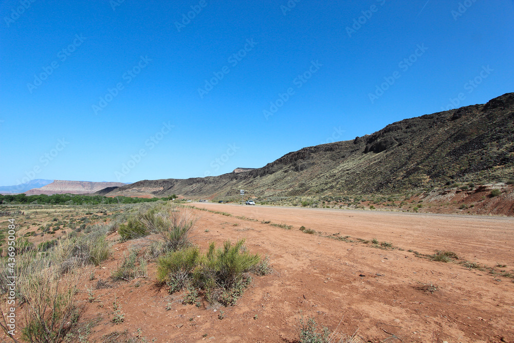 A road in Utah with Mountains and trees A road in Utah with Mountains and trees