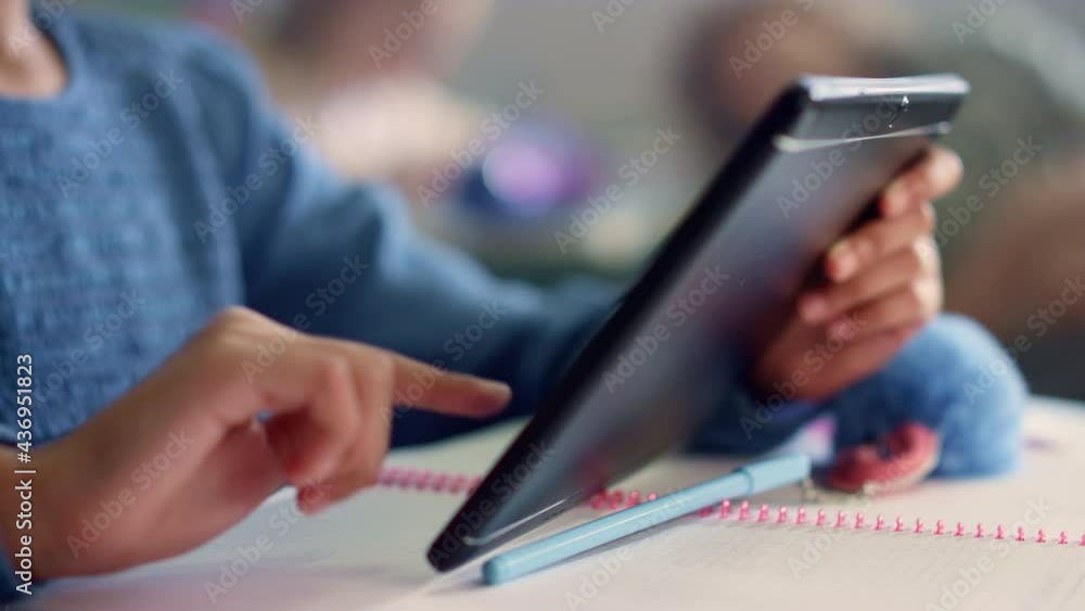 Student hand using digital tablet. Girl doing class work on tablet computer