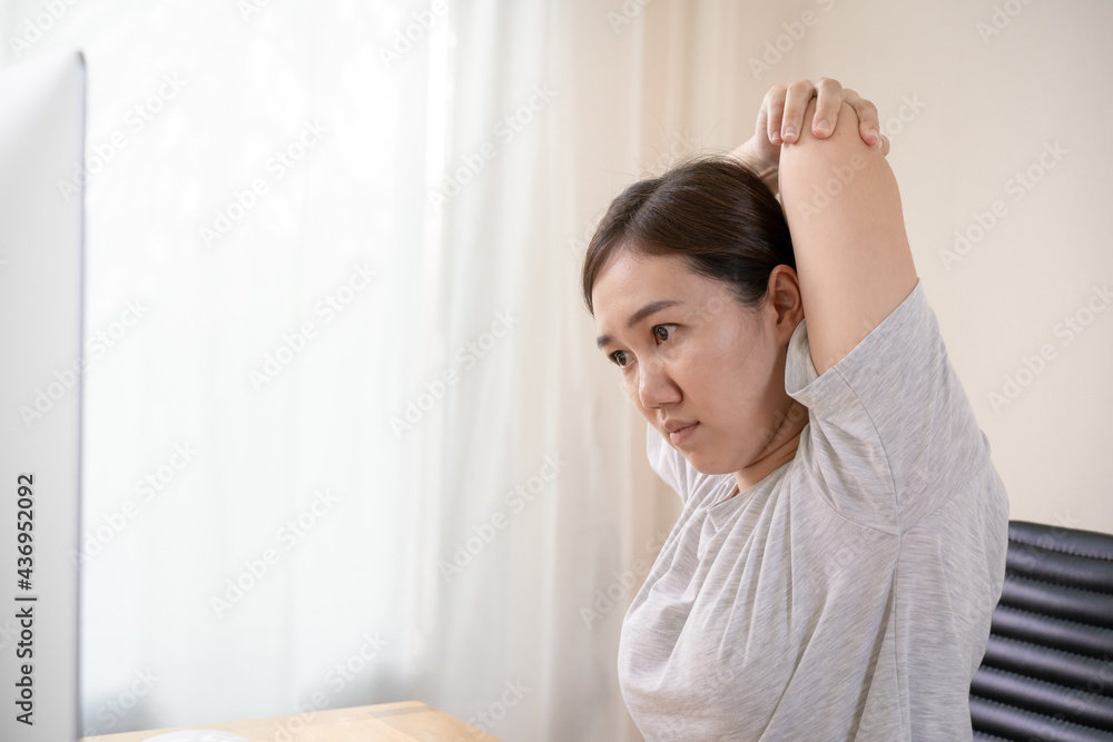 Young Asian woman having an office syndrome health problem.