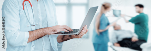 Wallpaper Mural Male Medical Doctor is Using Laptop for Examining Patient Health in Examination Room, Physical Doctor is Communicating on Computer Laptop While Visiting Diagnosis Patients. Medicine Doctors/Healthcare Torontodigital.ca