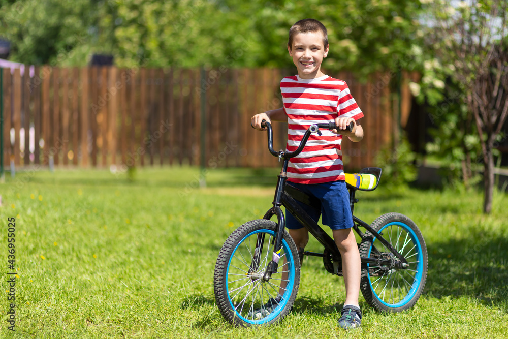 A young funny boy child riding bicycle or bike in the summer A young funny boy child riding bicycle or bike in the summer