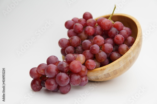 Wallpaper Mural Fresh and ripe red grapes in a wooden bowl, isolated in white background. Bunch of raw and juicy grapevines Torontodigital.ca