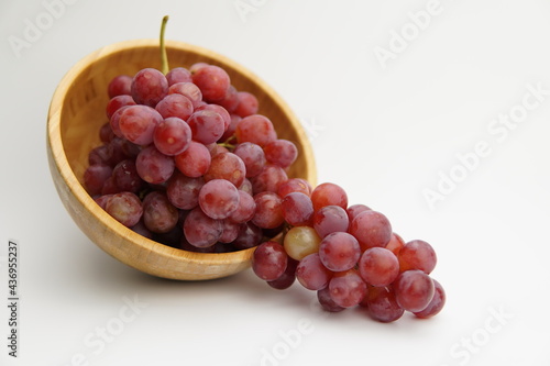 Wallpaper Mural Fresh and ripe red grapes in a wooden bowl, isolated in white background. Bunch of raw and juicy grapevines Torontodigital.ca