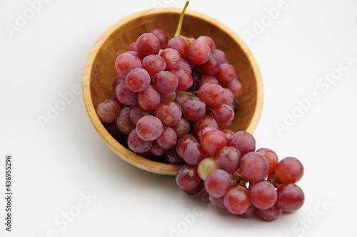Wallpaper Mural Fresh and ripe red grapes in a wooden bowl, isolated in white background. Bunch of raw and juicy grapevines Torontodigital.ca