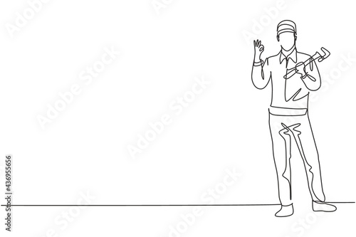 Continuous one line drawing plumber stands with gesture okay and holding carpentry tool fixing broken plumbing at home. Success business concept. Single line draw design vector graphic illustration