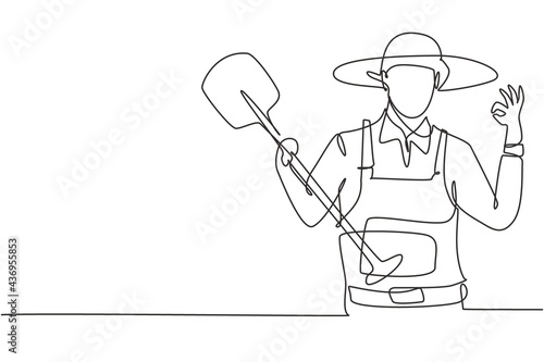 Single one line drawing of farmer with gesture okay wearing straw hat and carrying shovel to work on the farm. Success business concept. Modern continuous line draw design graphic vector illustration