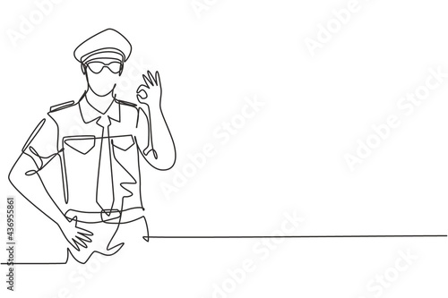 Single continuous line drawing male pilot with gesture okay and full uniform ready to fly with cabin crew in aircraft at international airport. Dynamic one line draw graphic design vector illustration