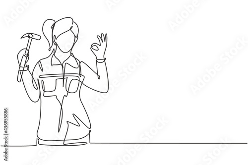 Single one line drawing female carpenter with gesture okay works in his workshop making wooden products. Skills in using carpentry tools. Modern continuous line draw design graphic vector illustration
