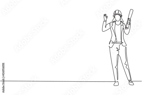 Continuous one line drawing female architect stood with gesture okay and wearing helmet carrying blueprint for building's work plan. Success job. Single line draw design vector graphic illustration